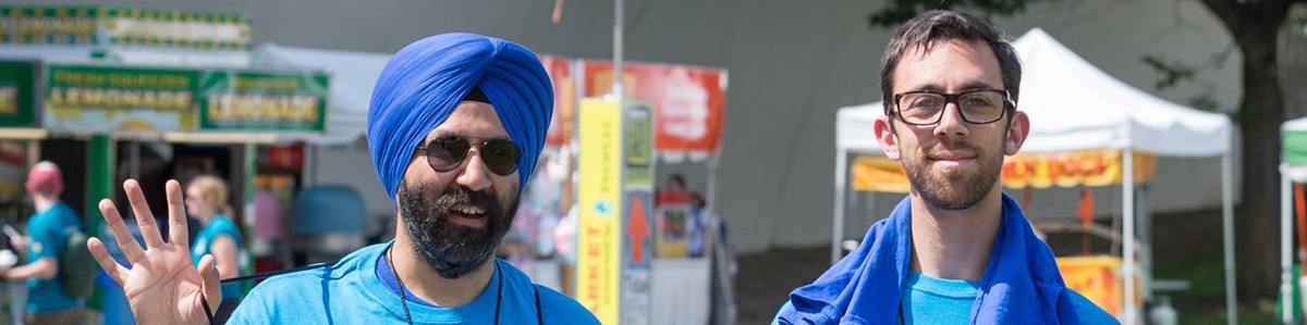 two three rivers arts festival volunteers wearing blue volunteer shirts