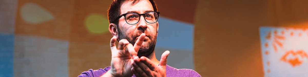 a sign language interpreter signing on stage during a concert