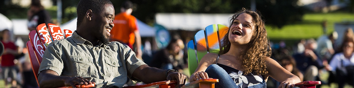 two visitors laugh with each other while sitting in point state park