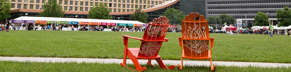 two empty chairs face the wyndham grand hotel in point state park